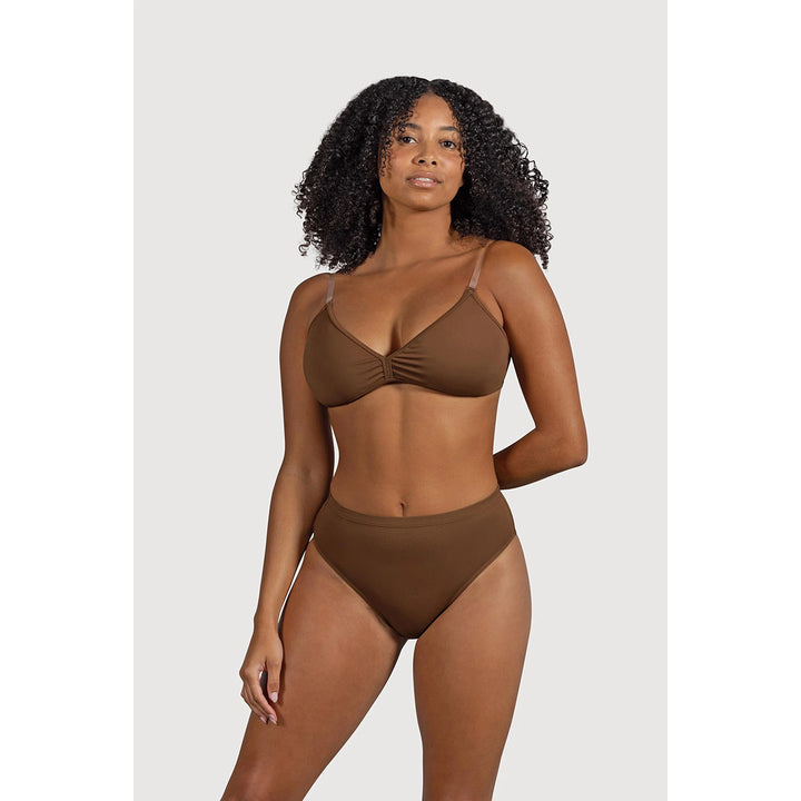A woman modeling a High Waist Womens Brief undergarment in a solid medium brown color, featuring a twisted front detail on the top and high-waisted bottoms, set against a plain light gray background.