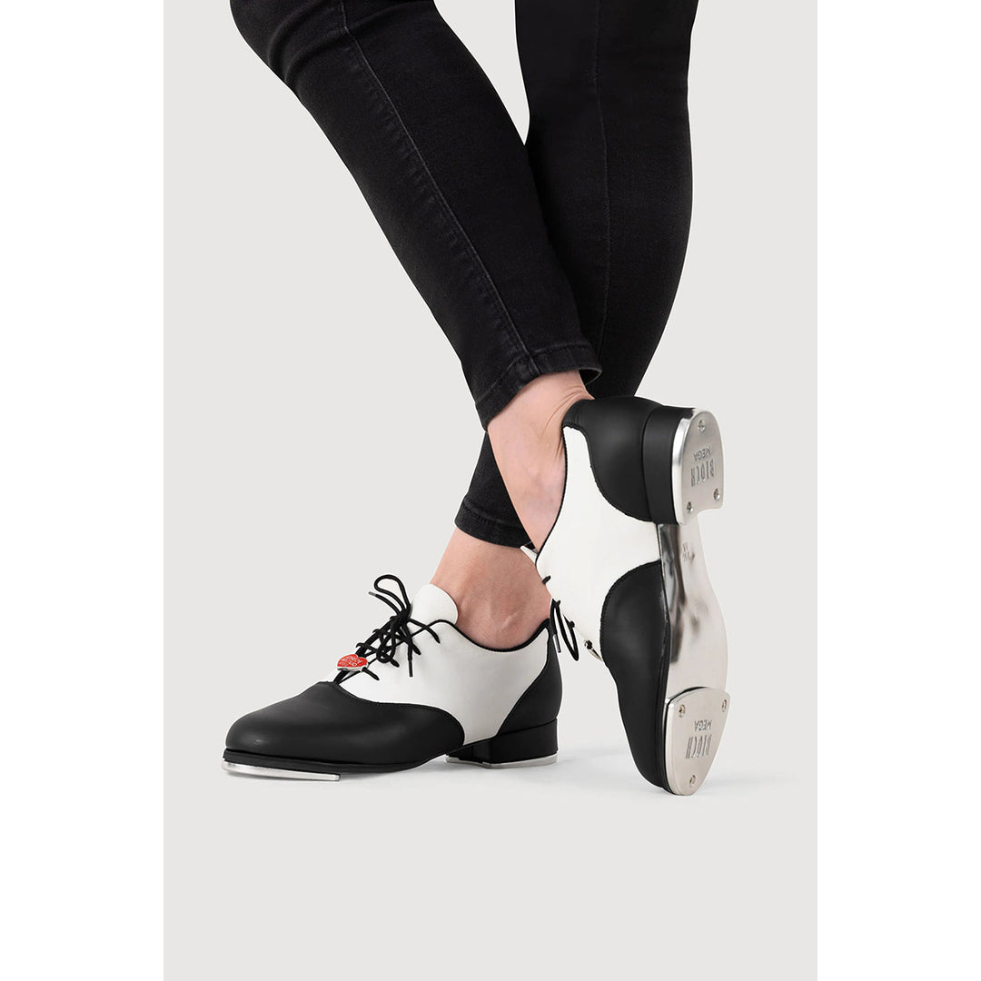 Black and white leather dance shoes with black laces, shown on a model&