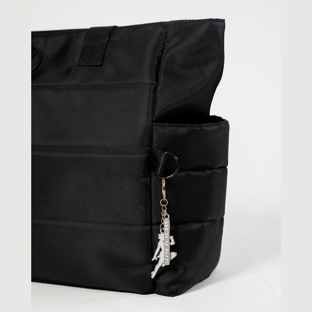 Energetiks white jazz dancer key ring hanging from a dance bag