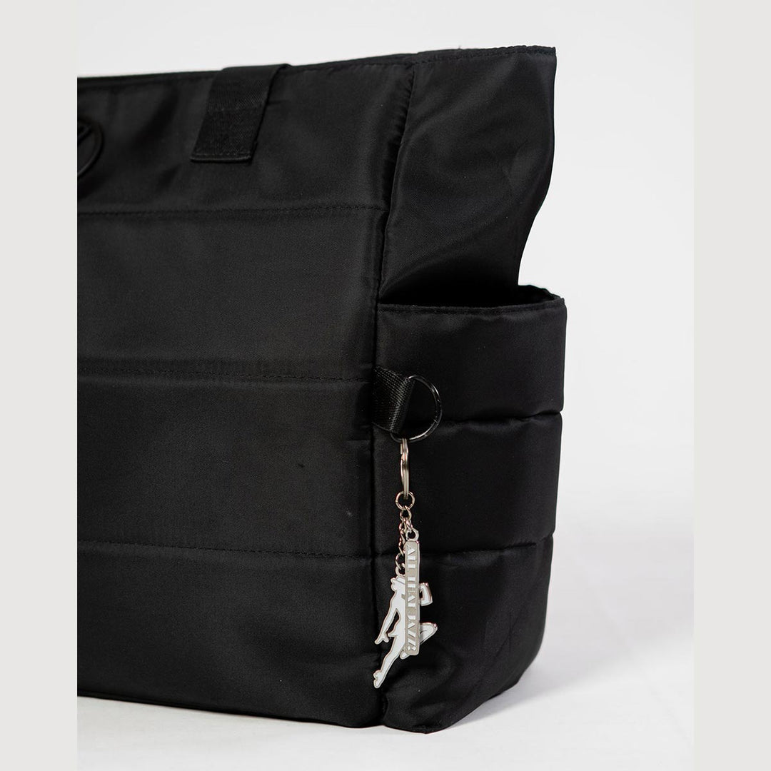Energetiks white jazz dancer key ring hanging from a dance bag