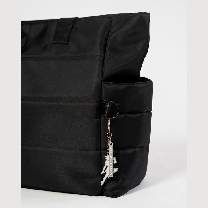 Energetiks white jazz dancer key ring hanging from a dance bag